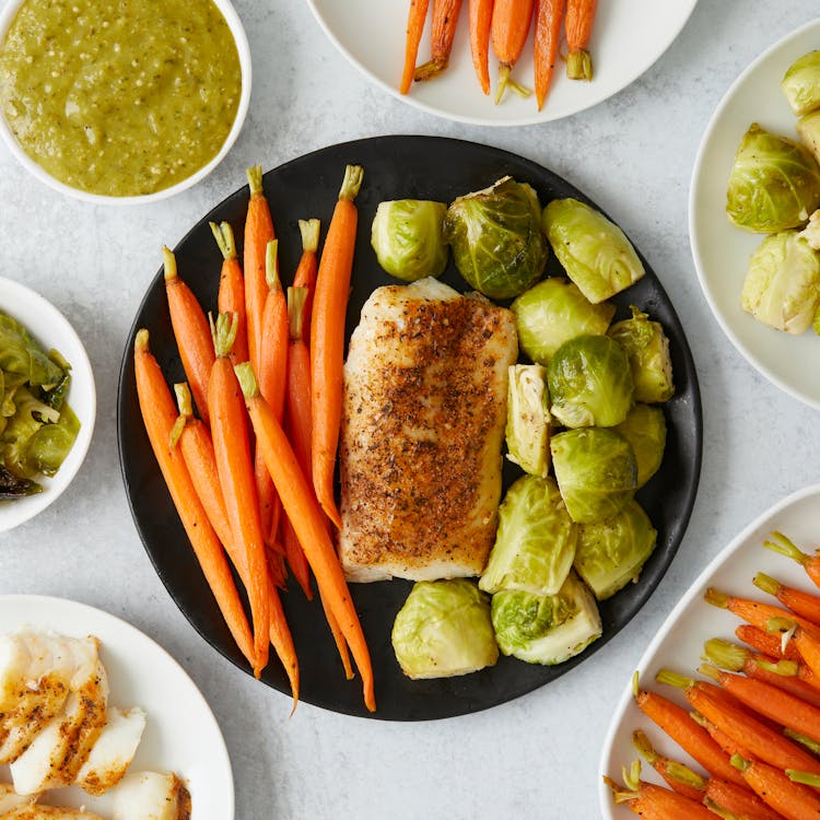 Best Dog Food UK 2026: Complete Guide to Choosing the Right Food for Your Dog Top view of nutritious healthy meal with carrots, Brussels sprouts and seasoned fish