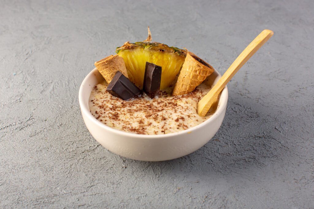 top view choco dessert brown with pineapple slice choco bars ice cream inside white plate grey